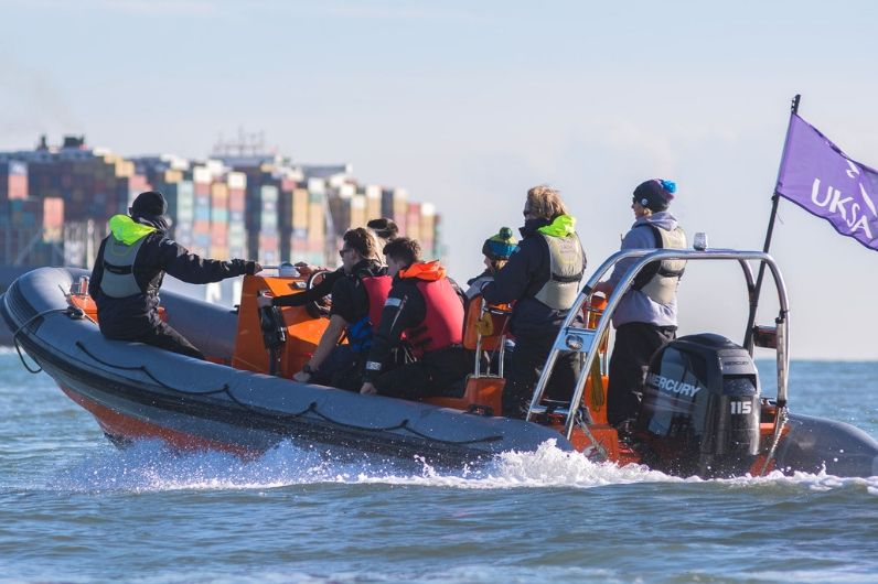 Multiple people onboard a powerboat on the Solent