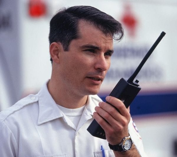 A ships security officer with a handheld radio