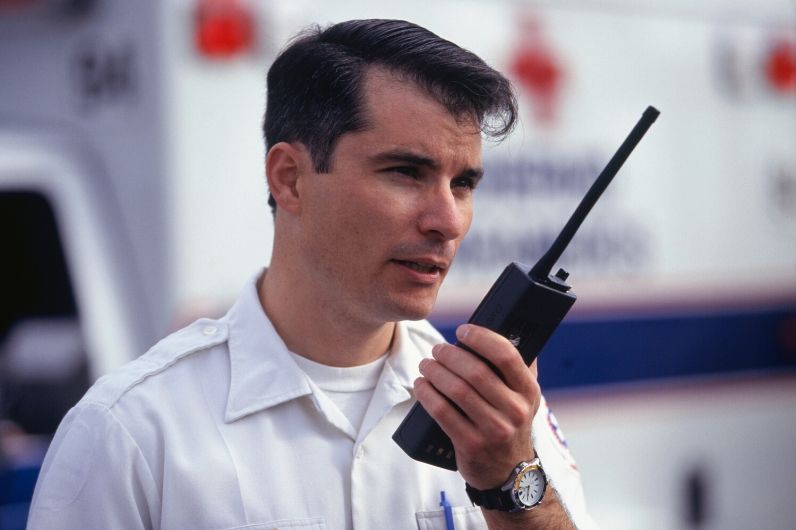 A ships security officer with a handheld radio