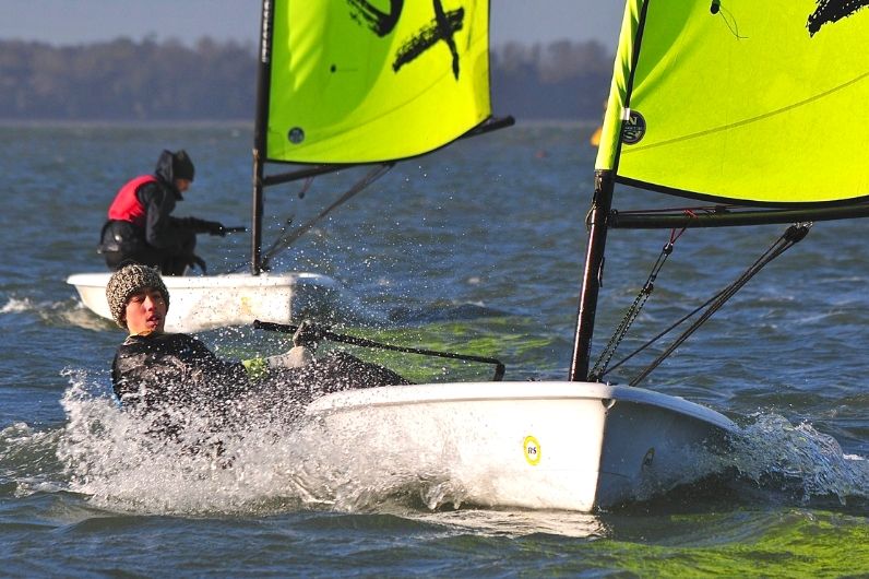 A young male learning how to dinghy sail on the open water