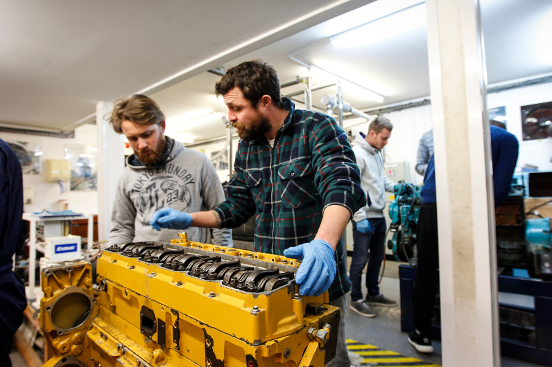 Students working on an engine on the MCA Approved Engine Course (AEC) course