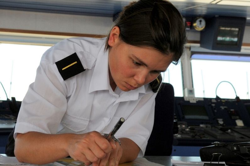 A female officer plotting a course on her chart