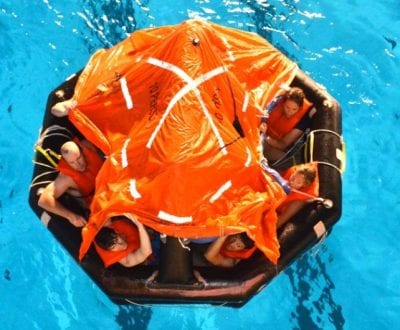 A life raft with students inside in a swimming pool