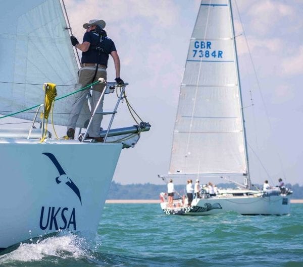 A UKSA trained sailor navigates a yacht.