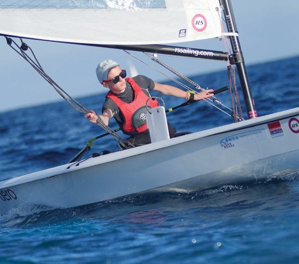 A young student navigating a dinghy