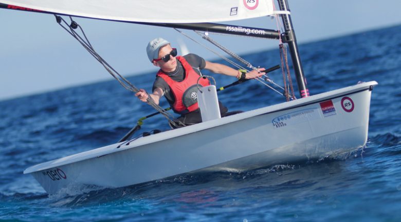 A young student navigating a dinghy
