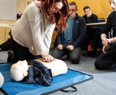 A student learning CPR in the classroom
