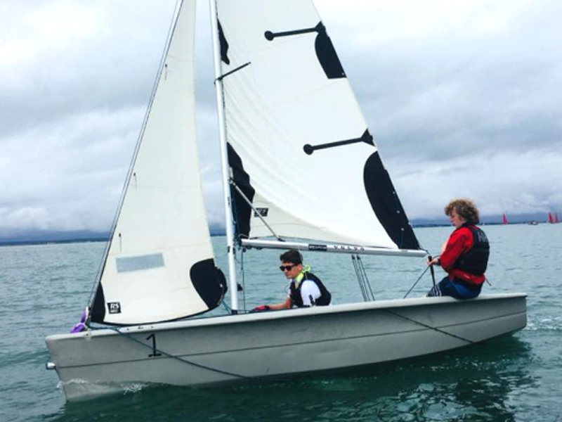 Salford Junior Sailing Club students on the water in a dinghy