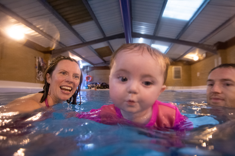 Baby learning to swim in toddler group