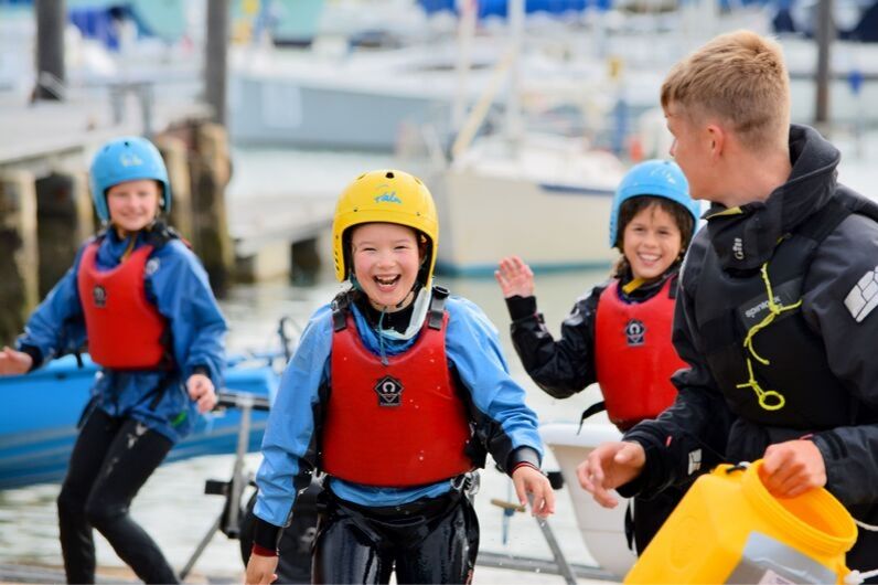 Children smiling with a UKSA instructor