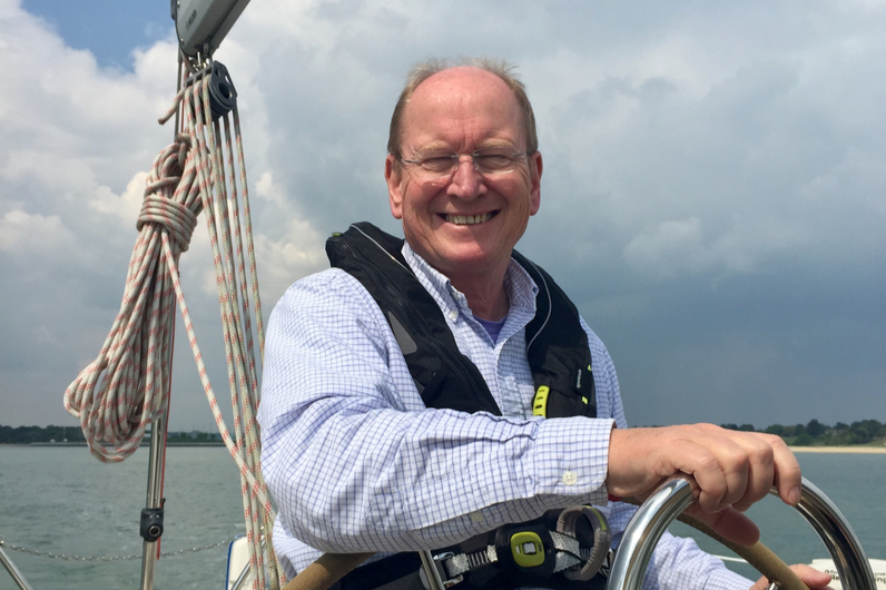 A yachtmaster graduate at the helm of a yacht