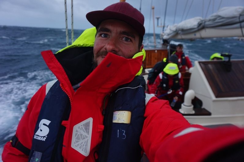 A young male taking a selfie onboard a yacht