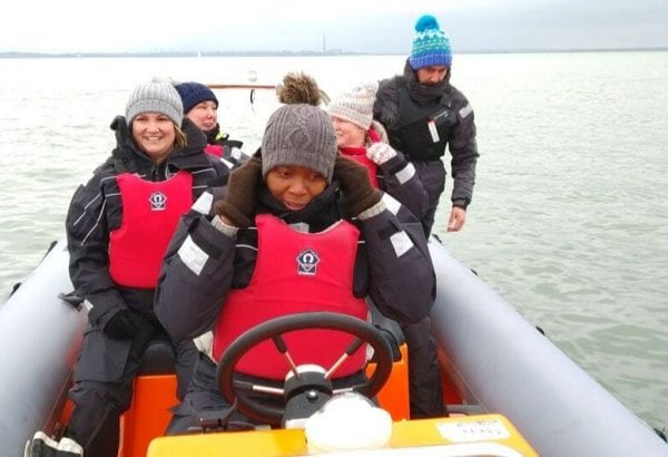Teachers in a power boat experiencing driving first hand