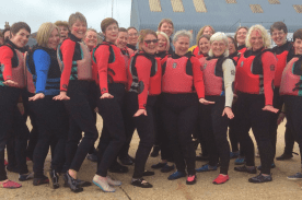A group shot of older ladies participating in a watersports activity