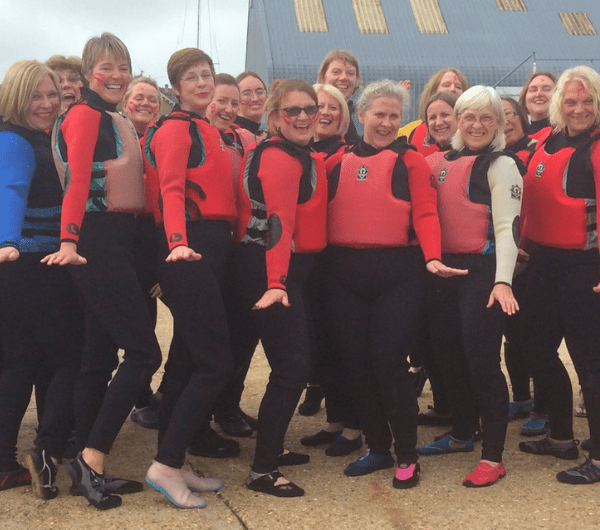 A group shot of older ladies participating in a watersports activity