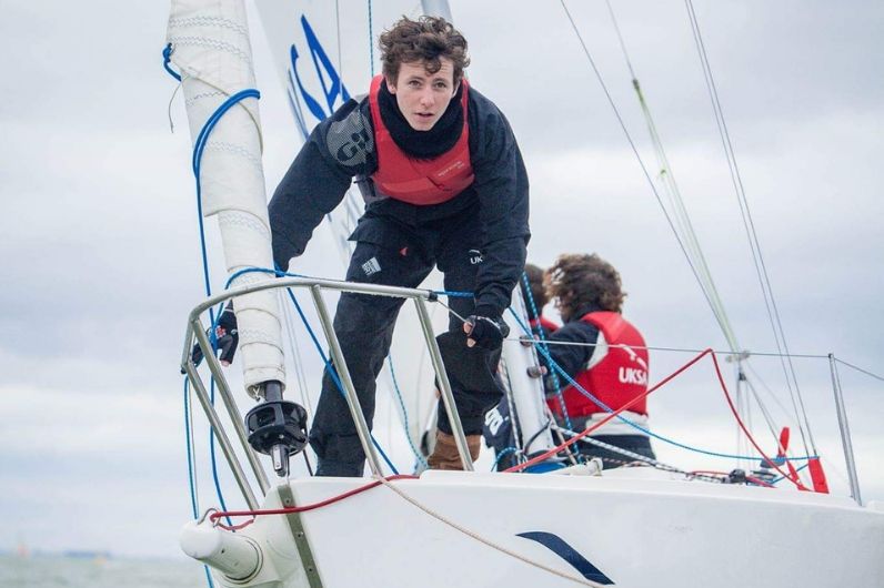 Sean Starkey on the bow of a yacht whilst training