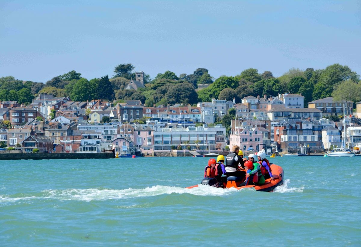 A powerboat with children on the Solent in Cowes