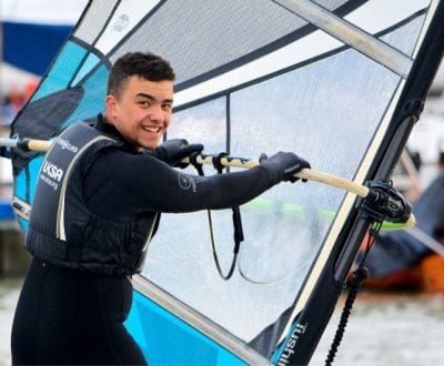 A young male learning to windsurf