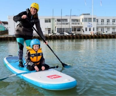 A young woman with her child at UKSA paddleboarding