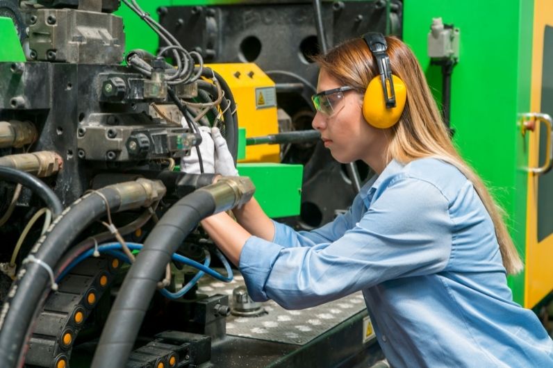 A young female working on a ships engine