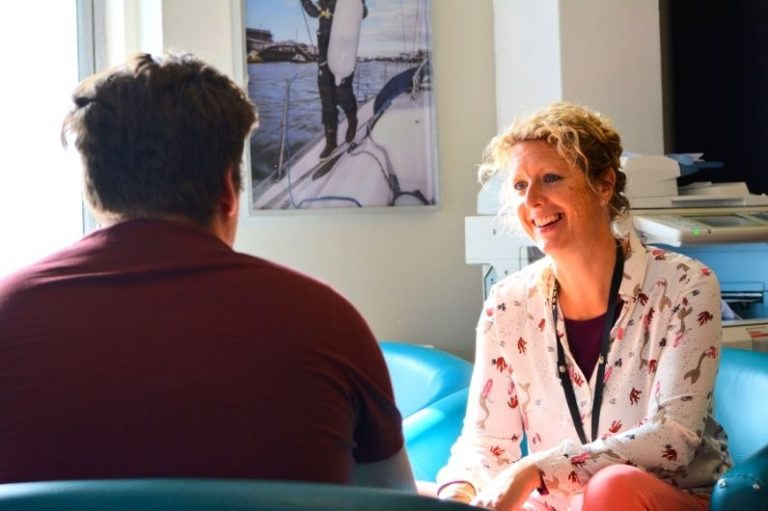 Welfare officer sitting with a student