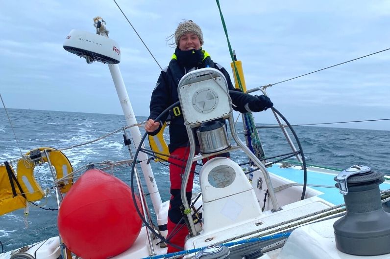 Holly Barnard steering a yacht