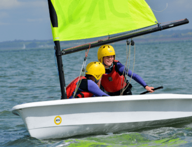 Dinghies are little sailing boats, usually with one sail to make it go – there’s no paddling! You’ll learn how to steer and make the dinghy go in the right direction. You and one or two friends will be the crew, in charge of the dinghy.