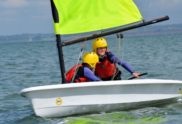 Dinghies are little sailing boats, usually with one sail to make it go – there’s no paddling! You’ll learn how to steer and make the dinghy go in the right direction. You and one or two friends will be the crew, in charge of the dinghy.
