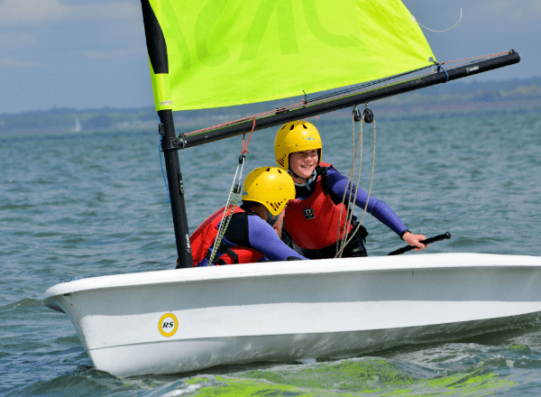 Dinghies are little sailing boats, usually with one sail to make it go – there’s no paddling! You’ll learn how to steer and make the dinghy go in the right direction. You and one or two friends will be the crew, in charge of the dinghy.