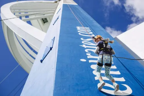 A woman abseiling down the Spinnaker Tower in Portsmouth
