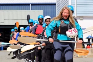 Watersport instructor at UKSA taking children for paddleboating