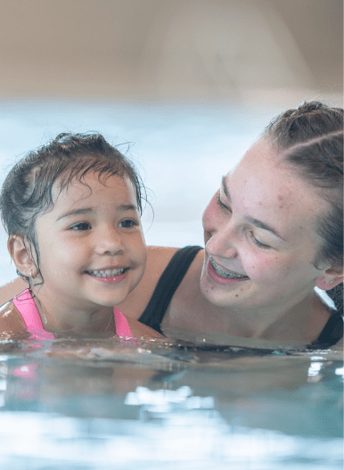 UKSA swimming instructor teaching child how to swim